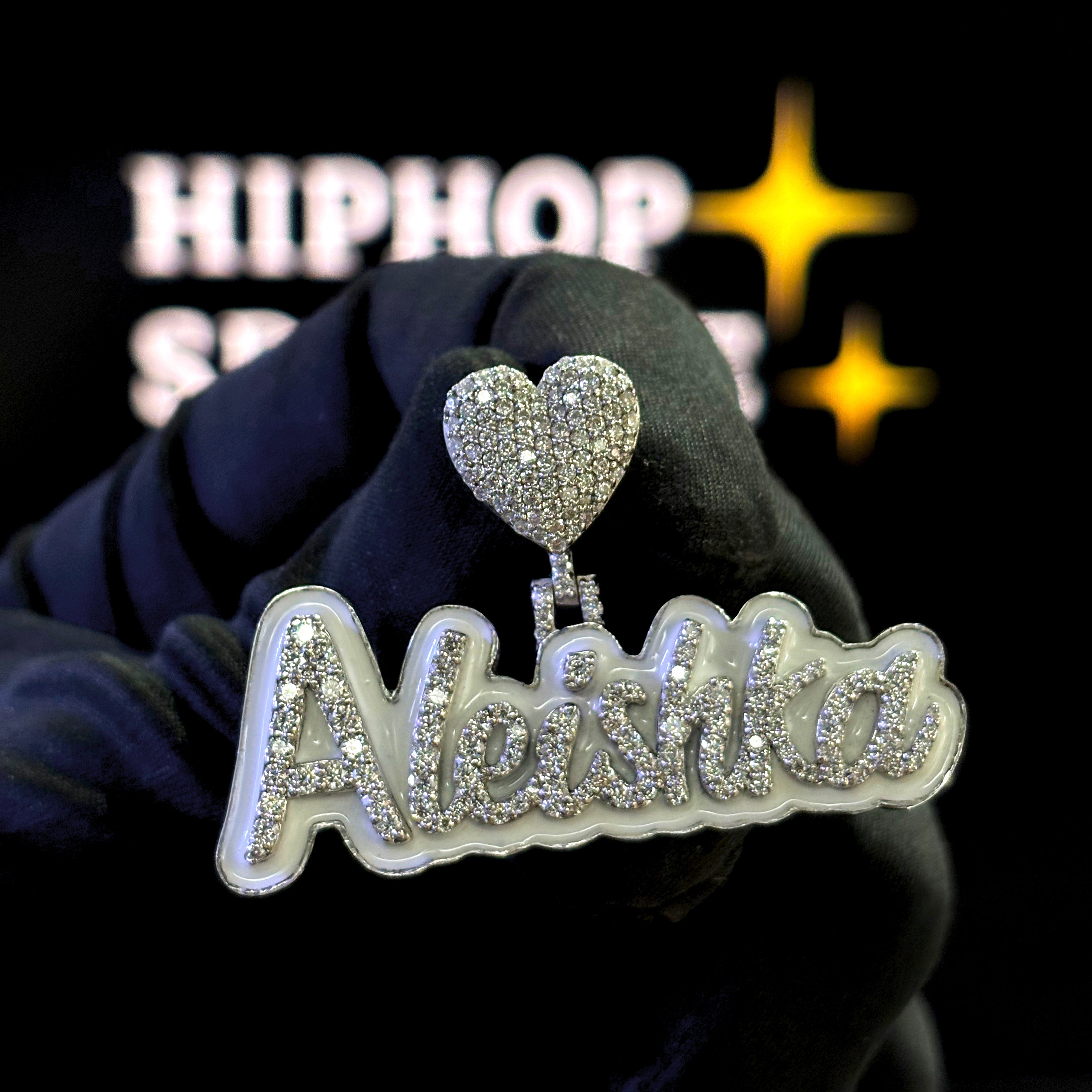 Aleishka custom name pendant in 925 silver iced out with VVS moissanite diamonds, white enamel background, 2-inch size, heart bail, hip hop jewelry.